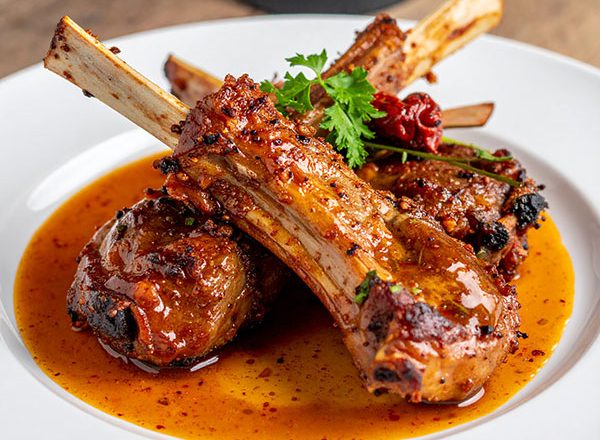 Wood-fired lamb ribs with harissa honey glaze